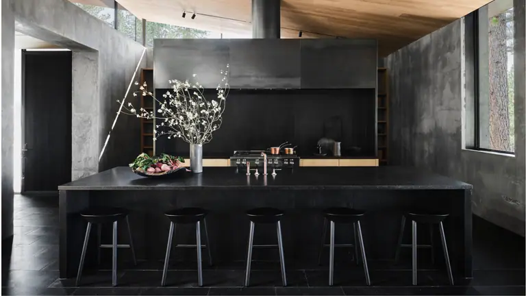 Dark stone kitchen with a long island and pendant lighting